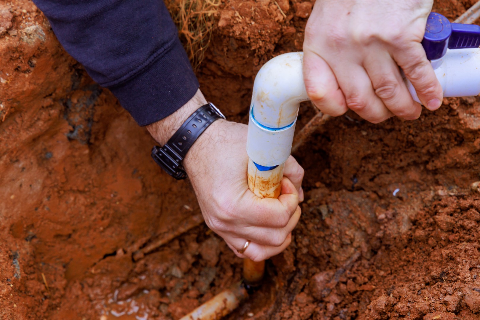 Installing glue pvc pipe to connect house to water supply