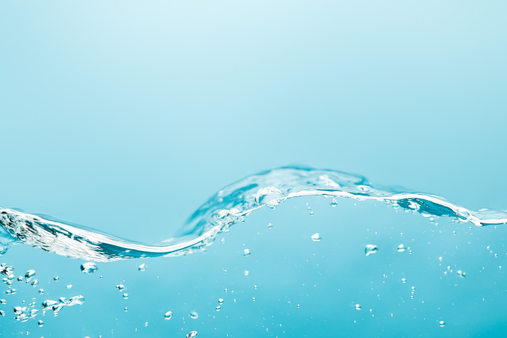 wavy transparent pure water with bubbles on blue background